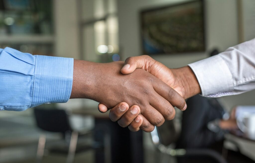 Professional handshake representing transparent public asset partnerships